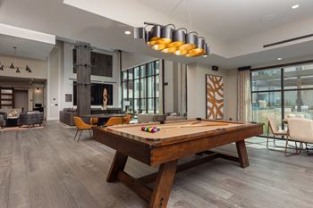 a pool table in the clubhouse at the bradley braddock road station apartments